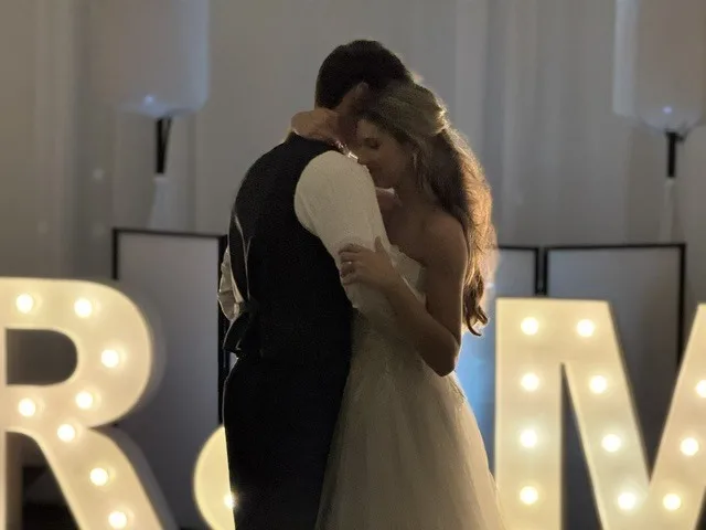 private last dance wedding couple tampa bay - Private Last Dance: Is it Worth It? Bride and groom sharing an intimate private last dance with illuminated marquee letters at their Tampa Bay wedding reception